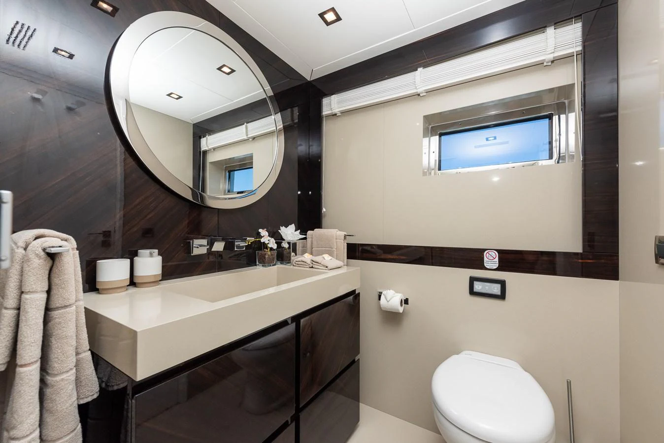 A modern and elegant yacht bathroom with sleek fixtures and a large mirror. aboard NYLA Yacht for Sale