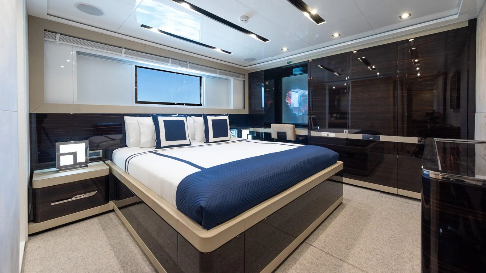 The master stateroom features a luxurious bed with elegant bedding and modern furnishings. aboard NYLA Yacht for Sale