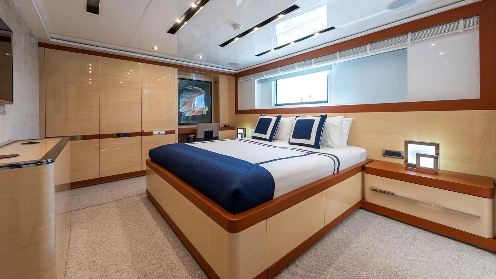 The stateroom features a spacious bed with elegant bedding and ample storage space. aboard NYLA Yacht for Sale