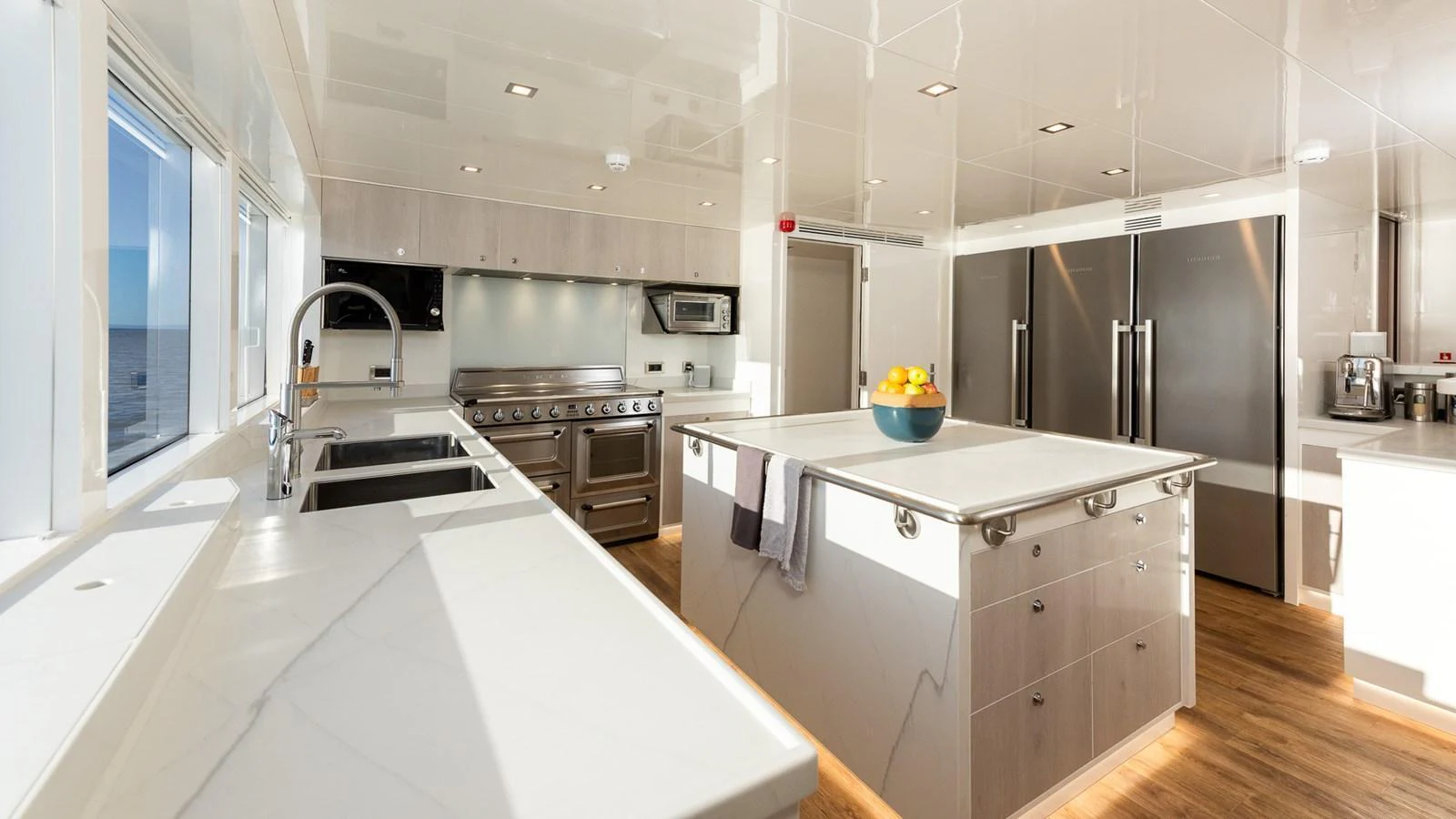 The galley features modern appliances and ample counter space with a bright and airy ambiance. aboard NYLA Yacht for Sale