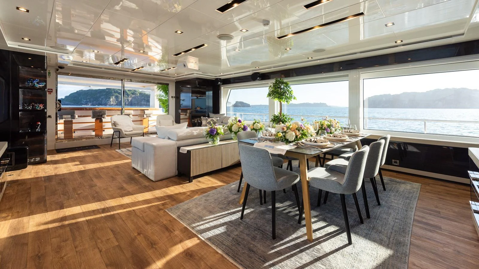 The spacious salon features elegant dining and lounging areas with panoramic views. aboard NYLA Yacht for Sale