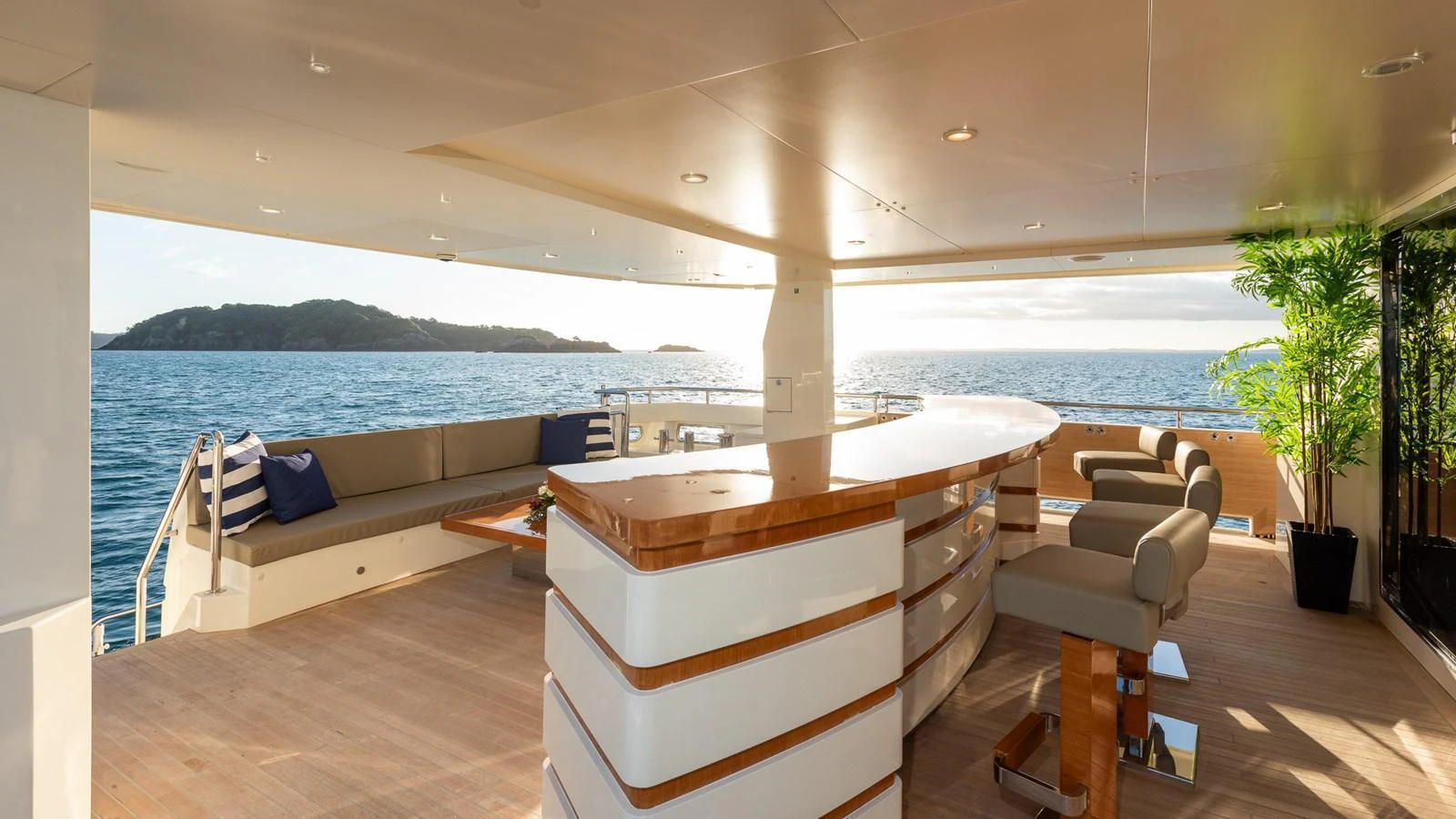 The aft deck features a stylish bar area with comfortable seating and scenic ocean views. aboard NYLA Yacht for Sale