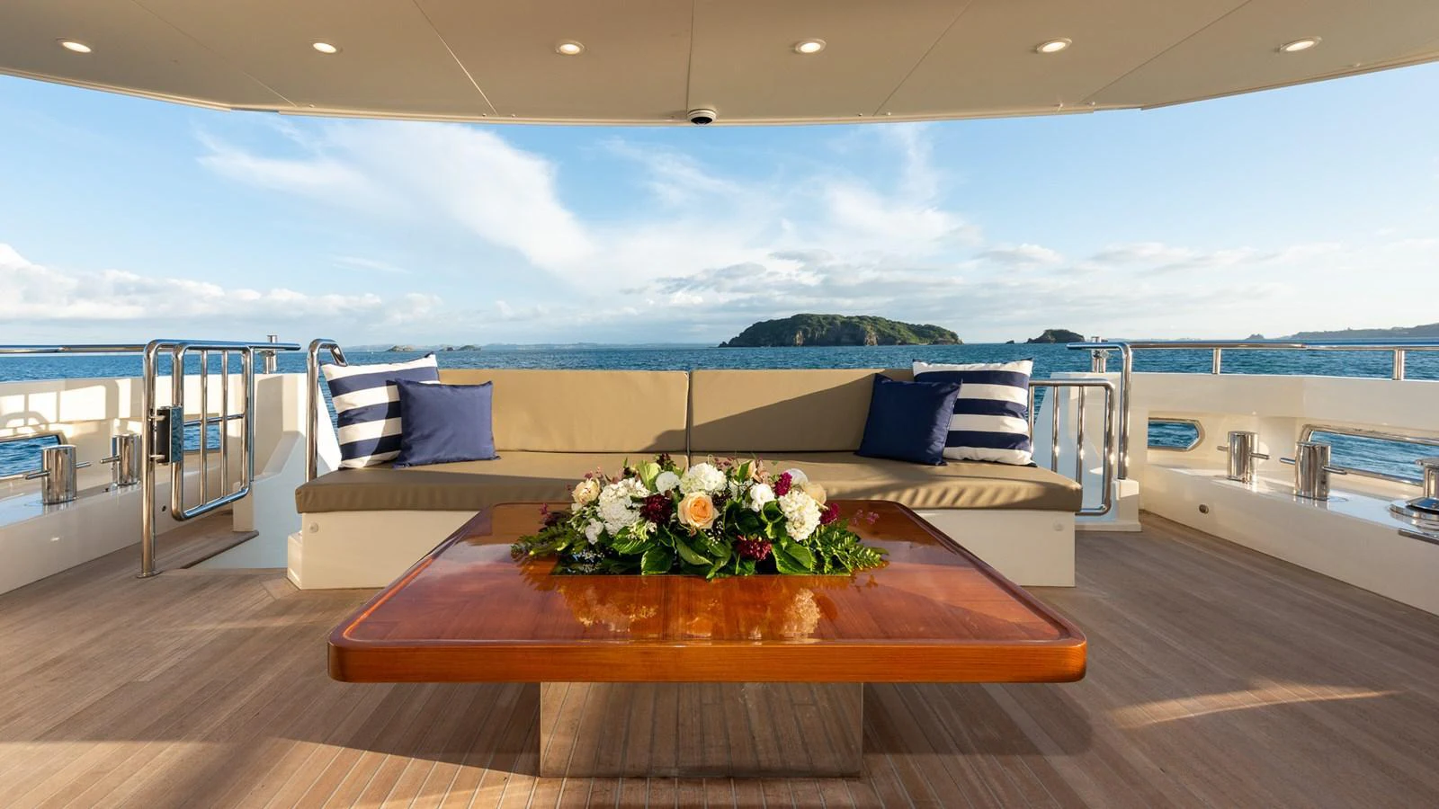 The aft deck offers a serene seating area with a beautiful ocean view, perfect for relaxation. aboard NYLA Yacht for Sale