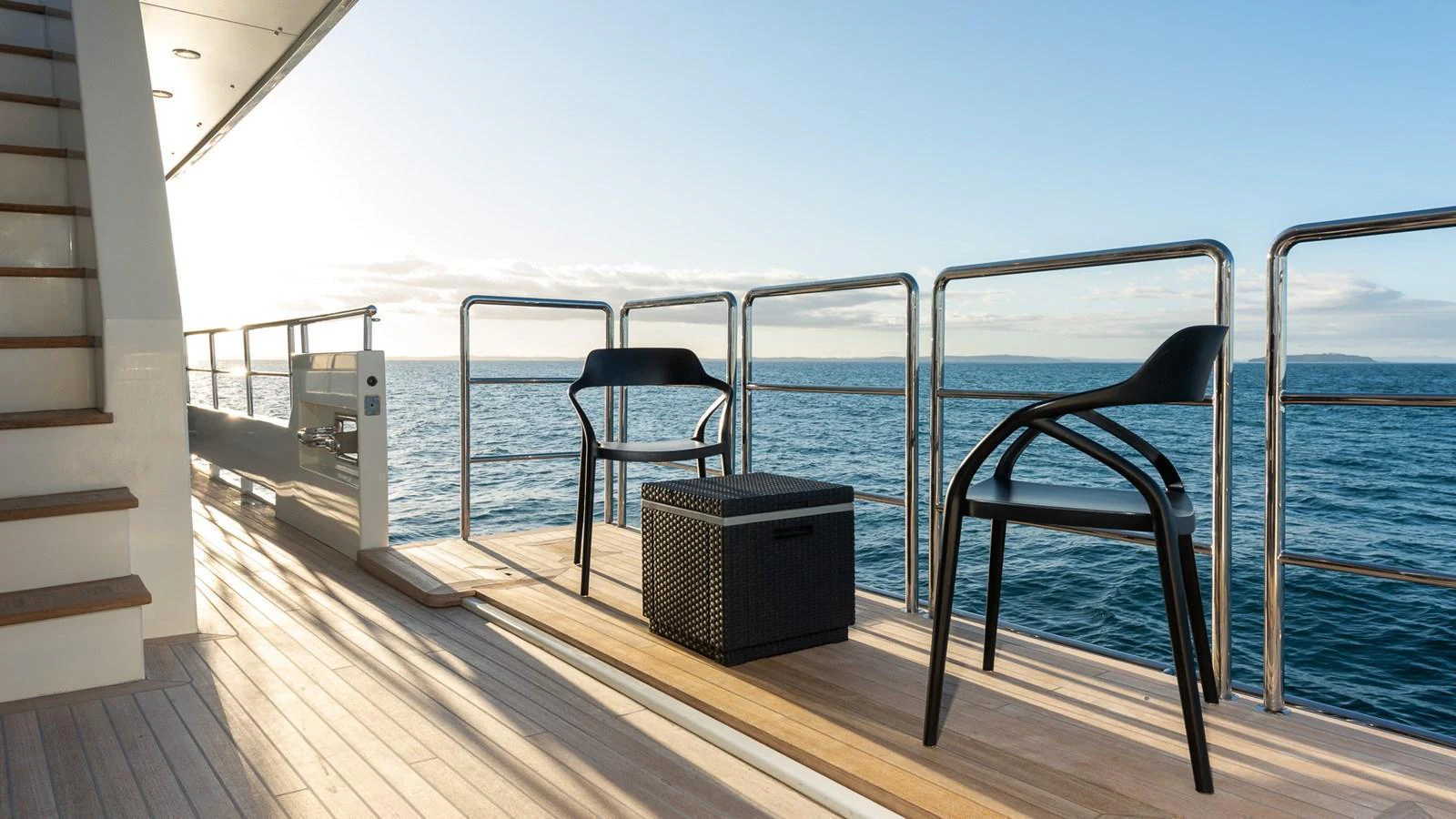The aft deck offers a serene space with modern seating and stunning ocean views. aboard NYLA Yacht for Sale