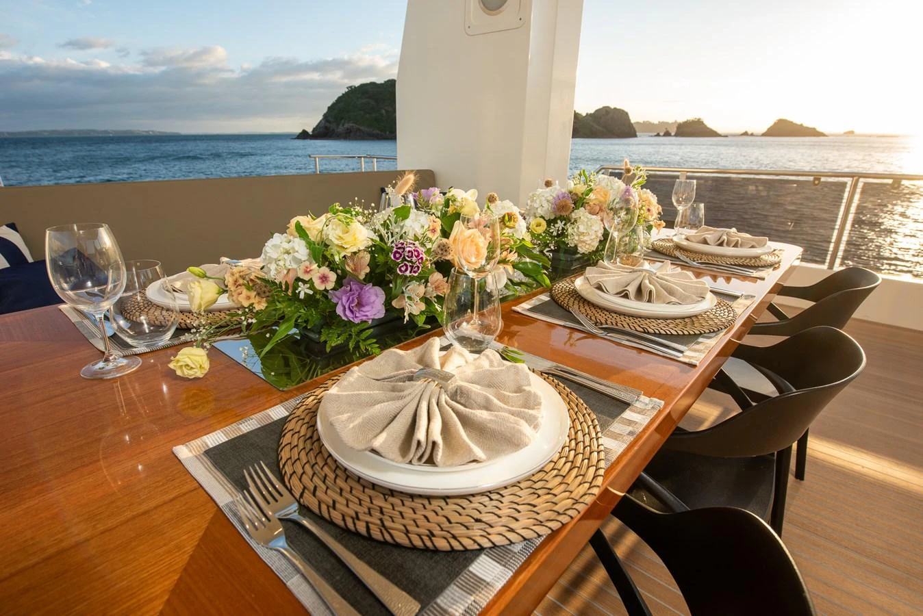An elegant dining area on the yacht, set with fine tableware and floral arrangements, overlooking the sea. aboard NYLA Yacht for Sale