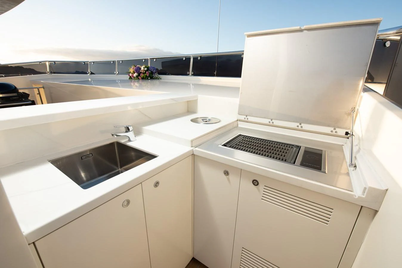 This image showcases a sleek outdoor galley with a grill and sink, perfect for alfresco dining. aboard NYLA Yacht for Sale