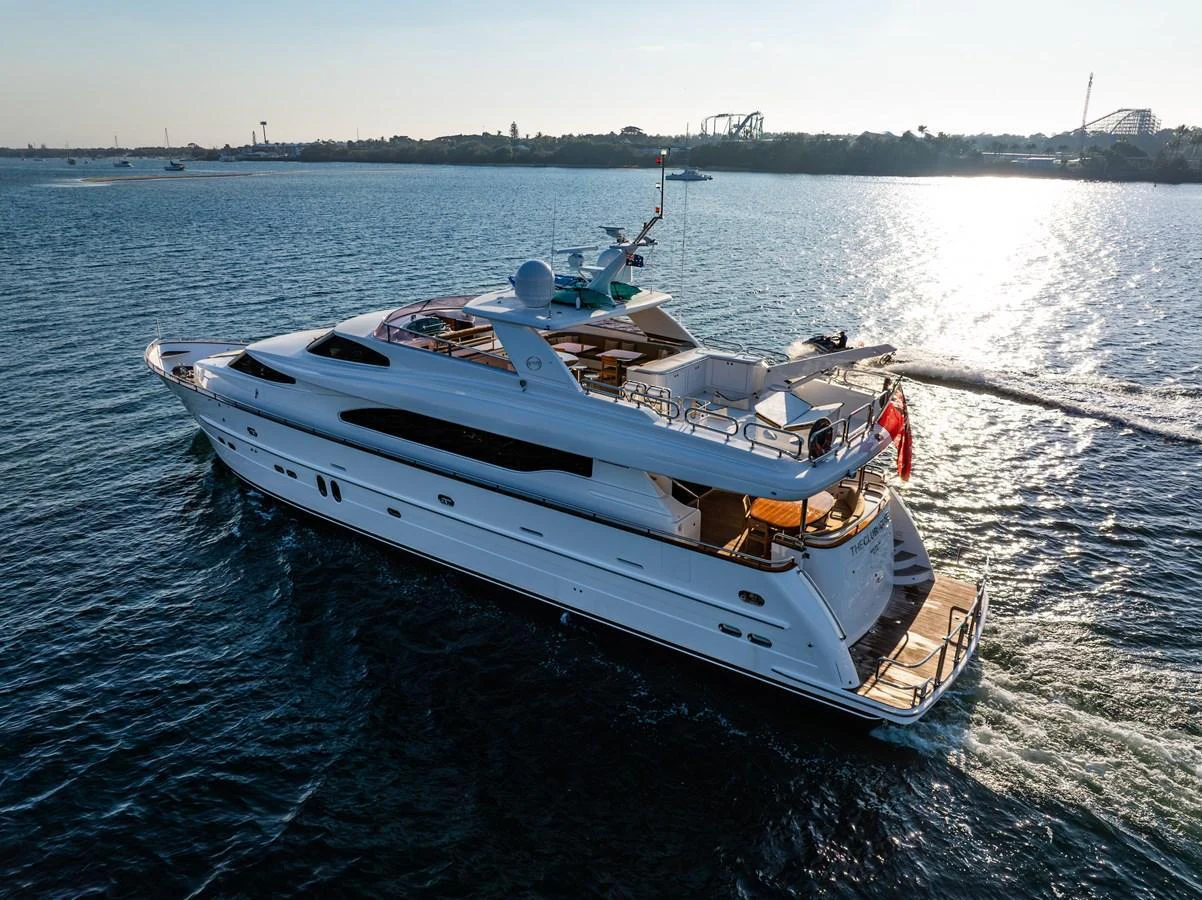 A sleek and elegant yacht cruises gracefully on calm waters, showcasing its luxurious design and spacious decks. aboard THE CLUBHOUSE Yacht for Sale