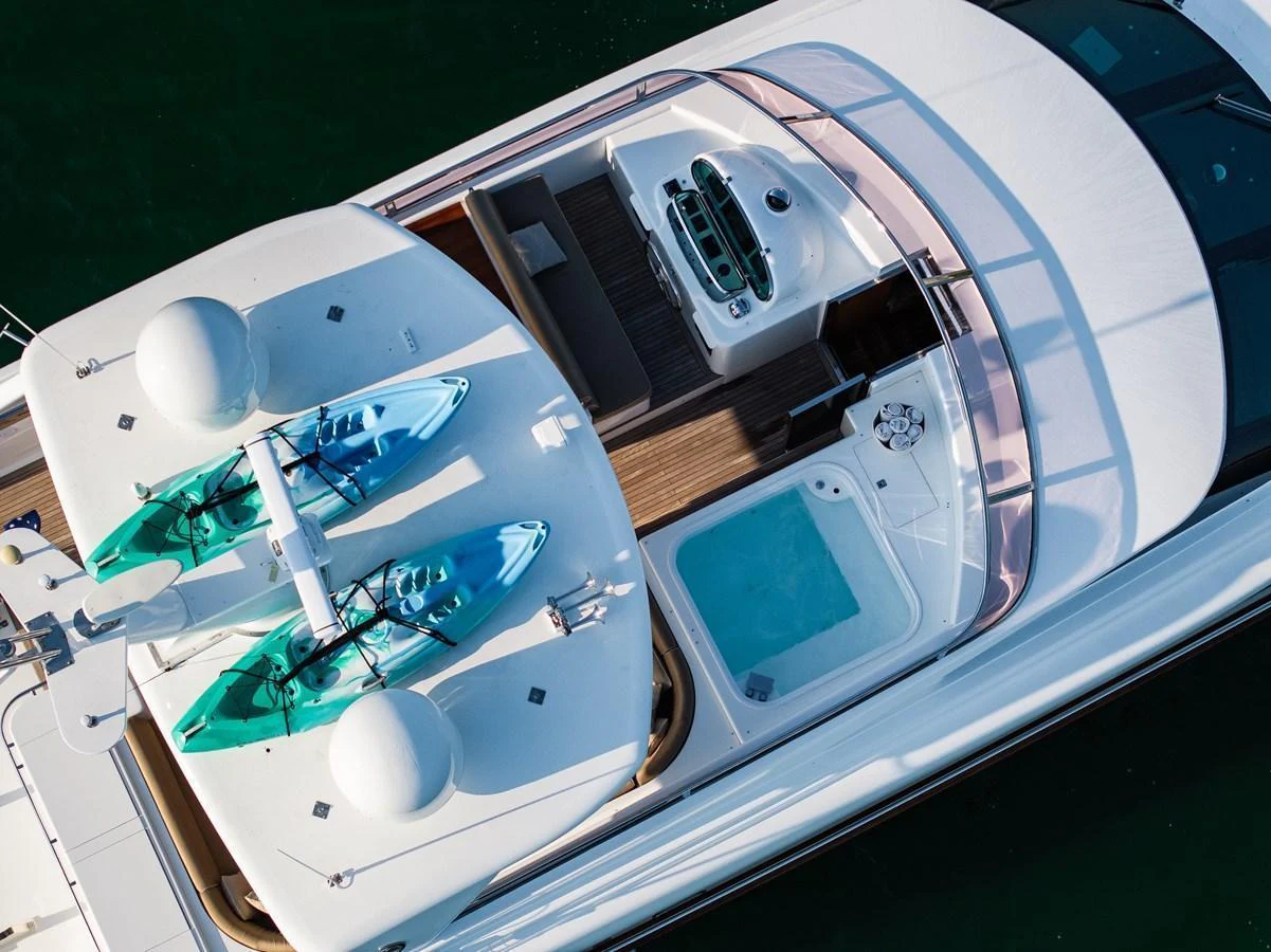 The sundeck features kayaks, a hot tub, and ample lounging space for relaxation. aboard THE CLUBHOUSE Yacht for Sale
