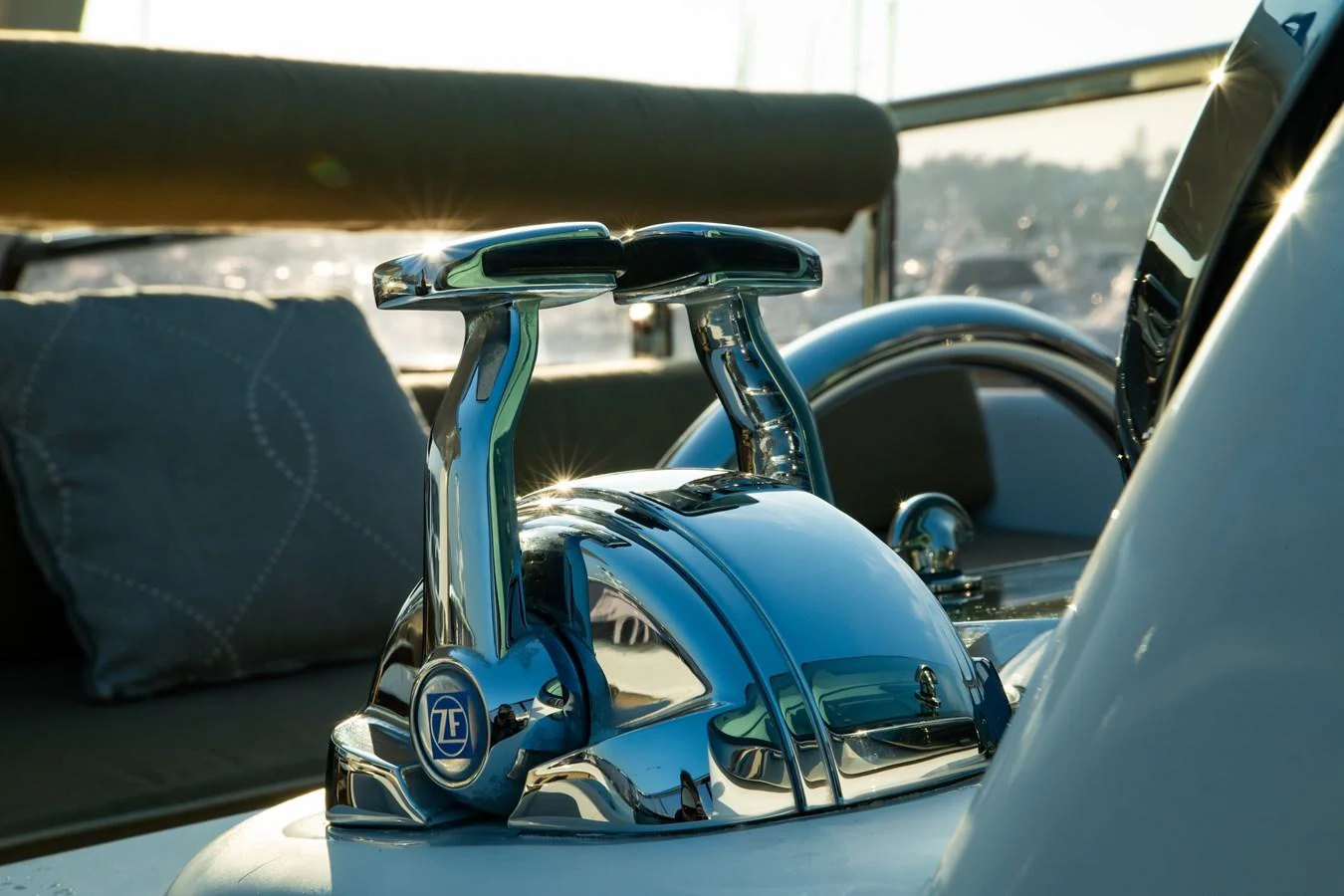 A close-up view of the yacht's polished chrome throttle controls, reflecting the sunlight. aboard THE CLUBHOUSE Yacht for Sale
