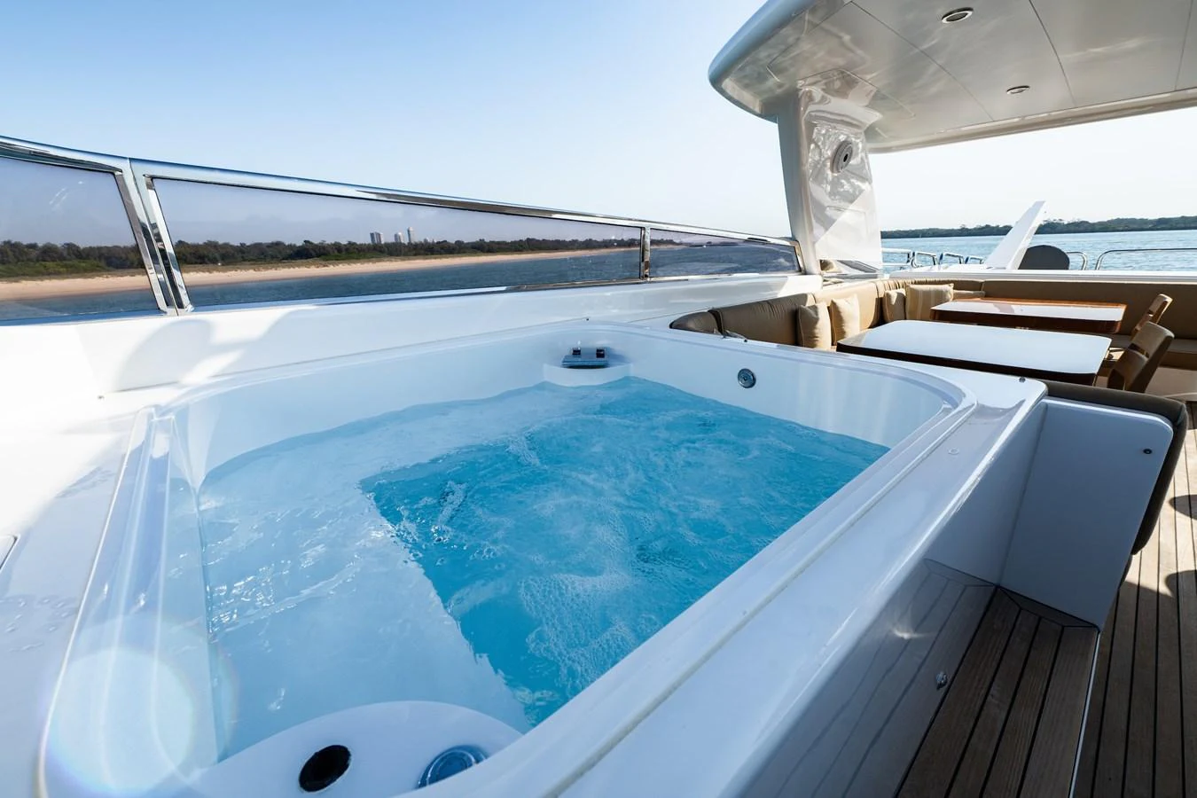 The sundeck features a luxurious jacuzzi with a stunning view of the water. aboard THE CLUBHOUSE Yacht for Sale