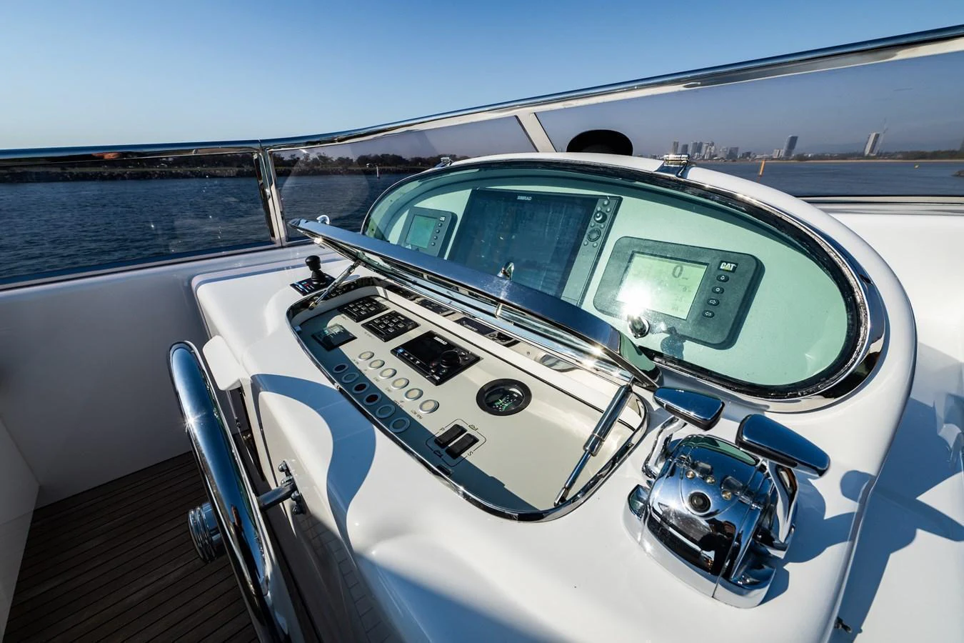 The helm station features advanced navigation equipment and a sleek, modern design. aboard THE CLUBHOUSE Yacht for Sale