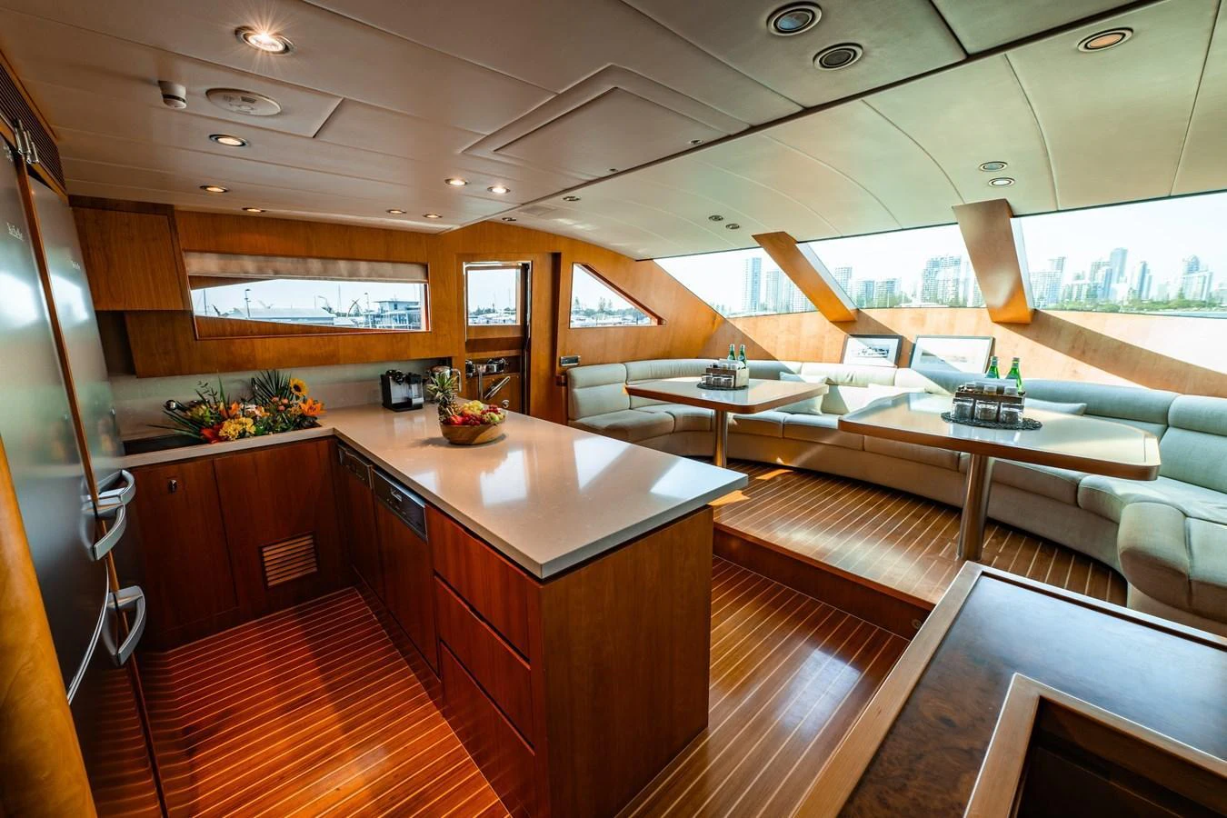 The yacht's galley features a spacious and modern design with ample seating and large windows offering stunning views. aboard THE CLUBHOUSE Yacht for Sale