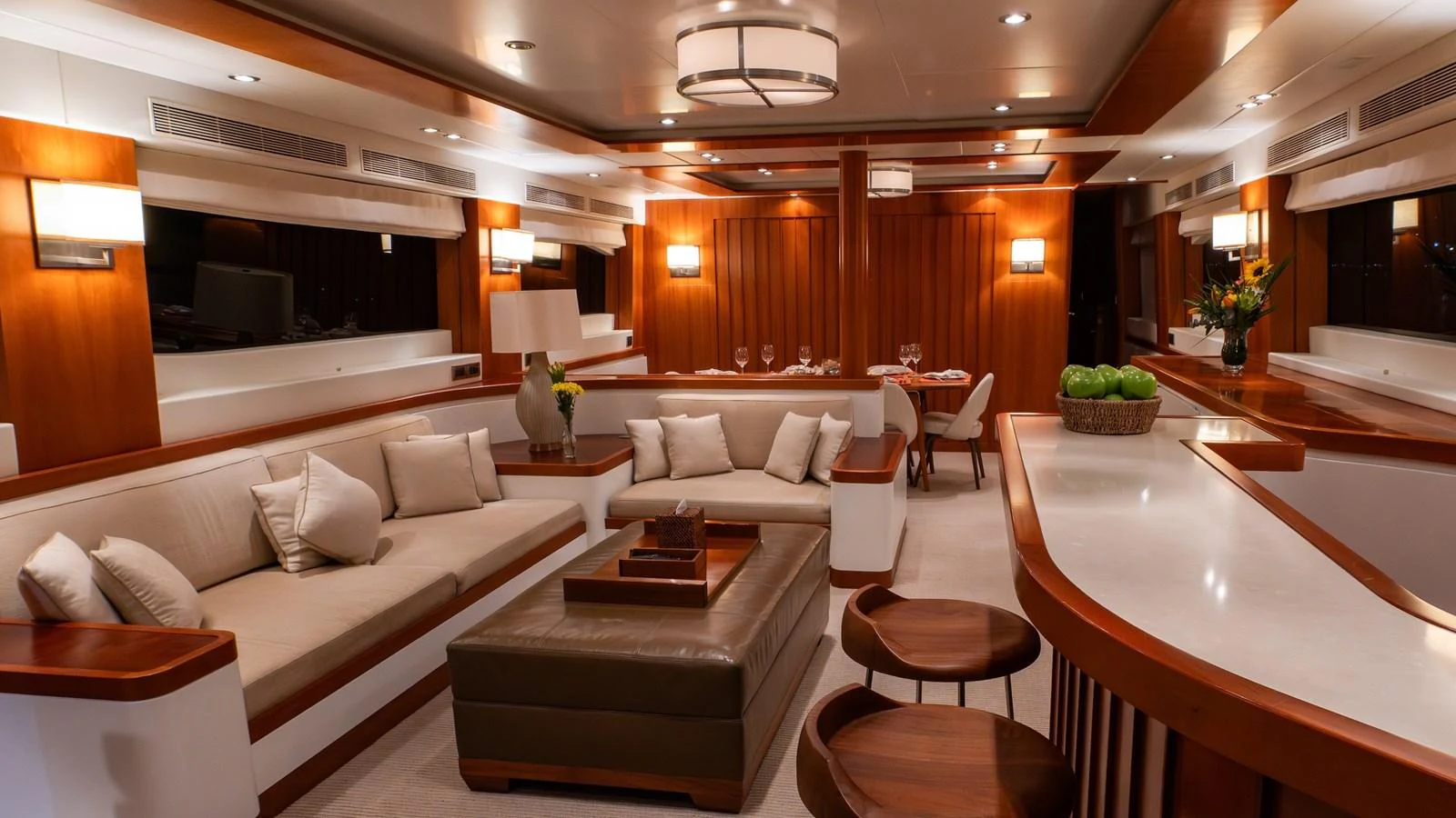 The yacht's salon features elegant wood paneling, plush seating, and a sophisticated dining area. aboard THE CLUBHOUSE Yacht for Sale