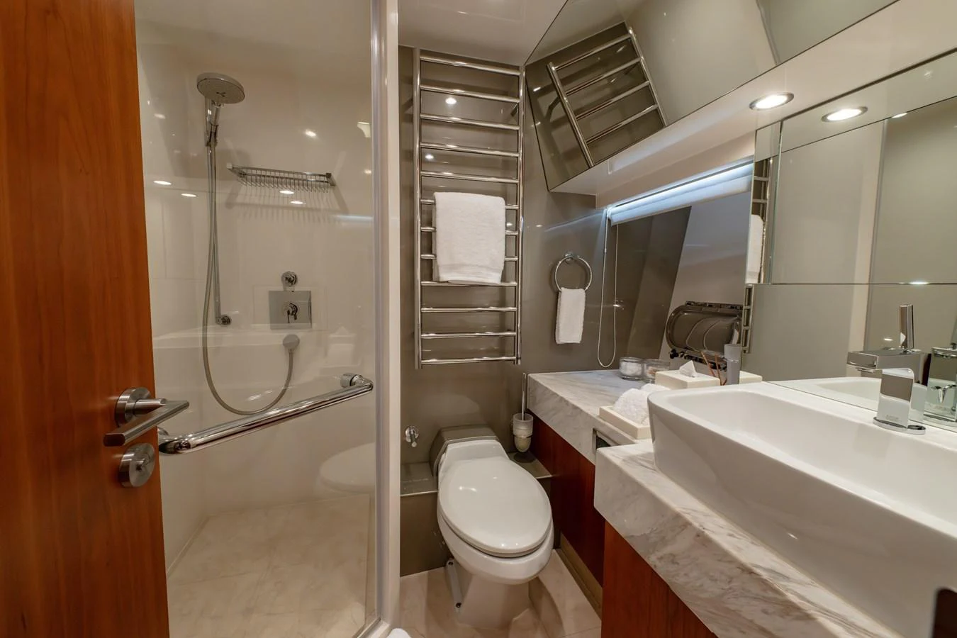 A modern yacht bathroom featuring a spacious shower and elegant fixtures. aboard THE CLUBHOUSE Yacht for Sale