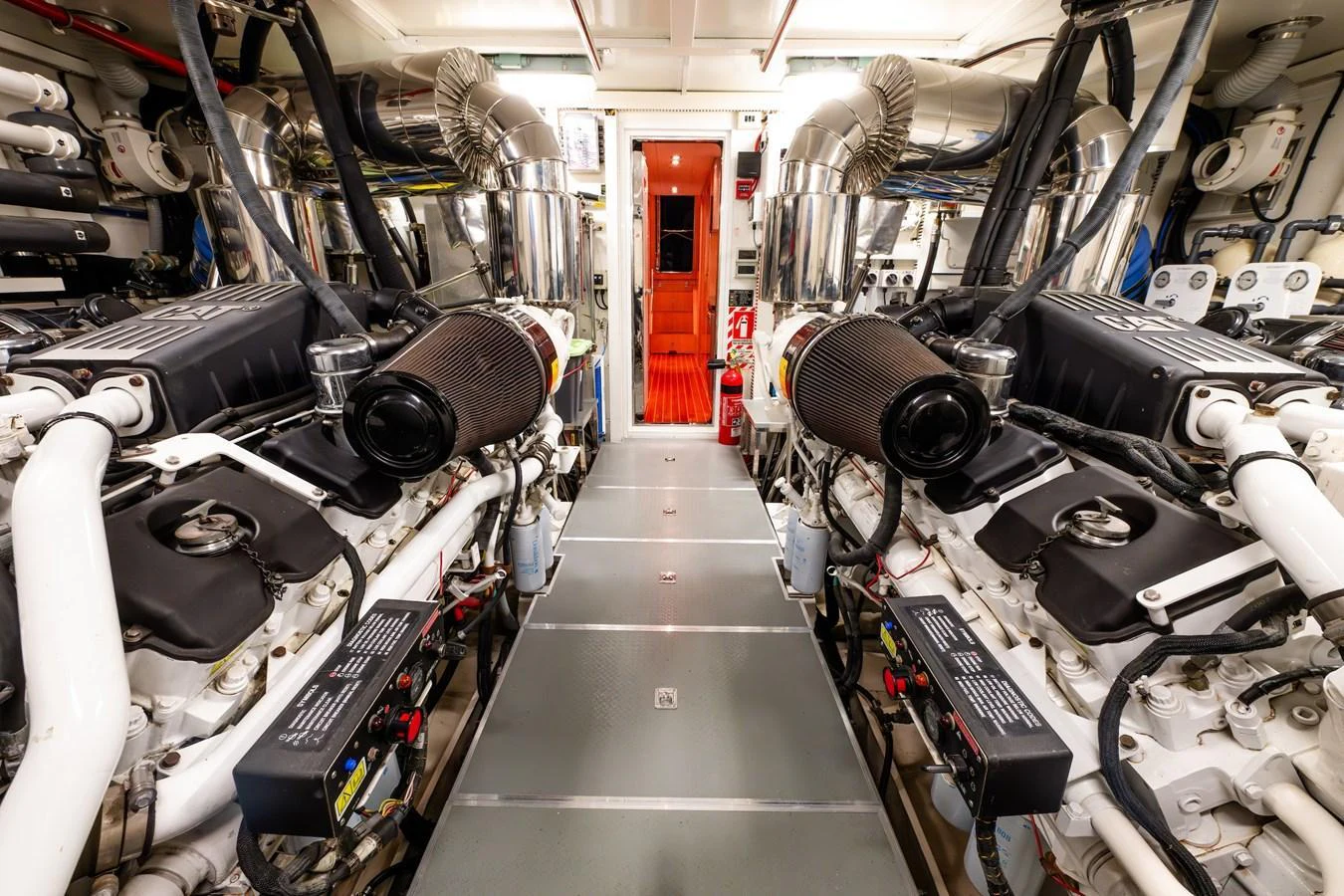 The engine room showcases powerful machinery and meticulous organization. aboard THE CLUBHOUSE Yacht for Sale