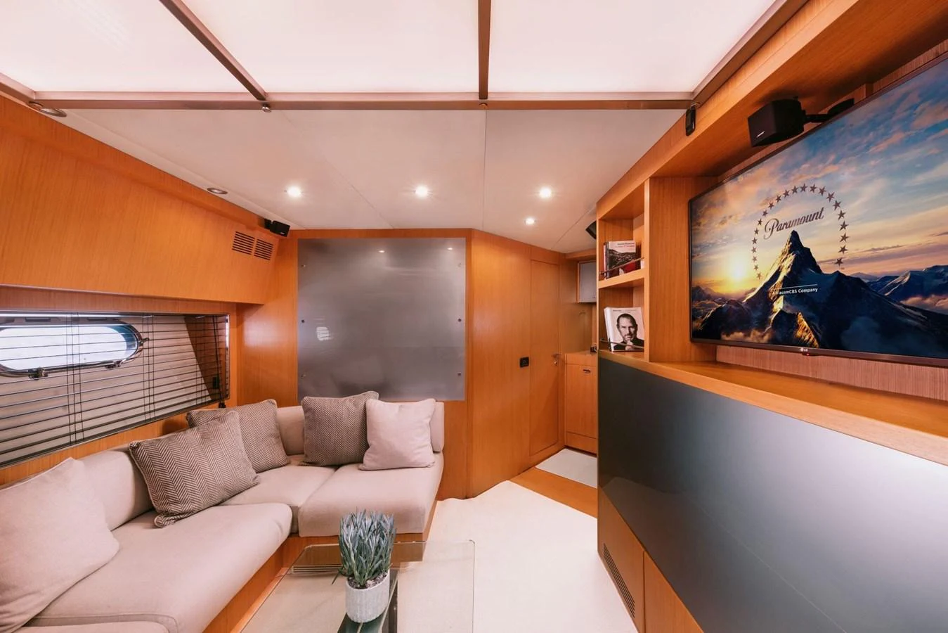 a room with a couch and a television aboard WHO CARES Yacht for Sale