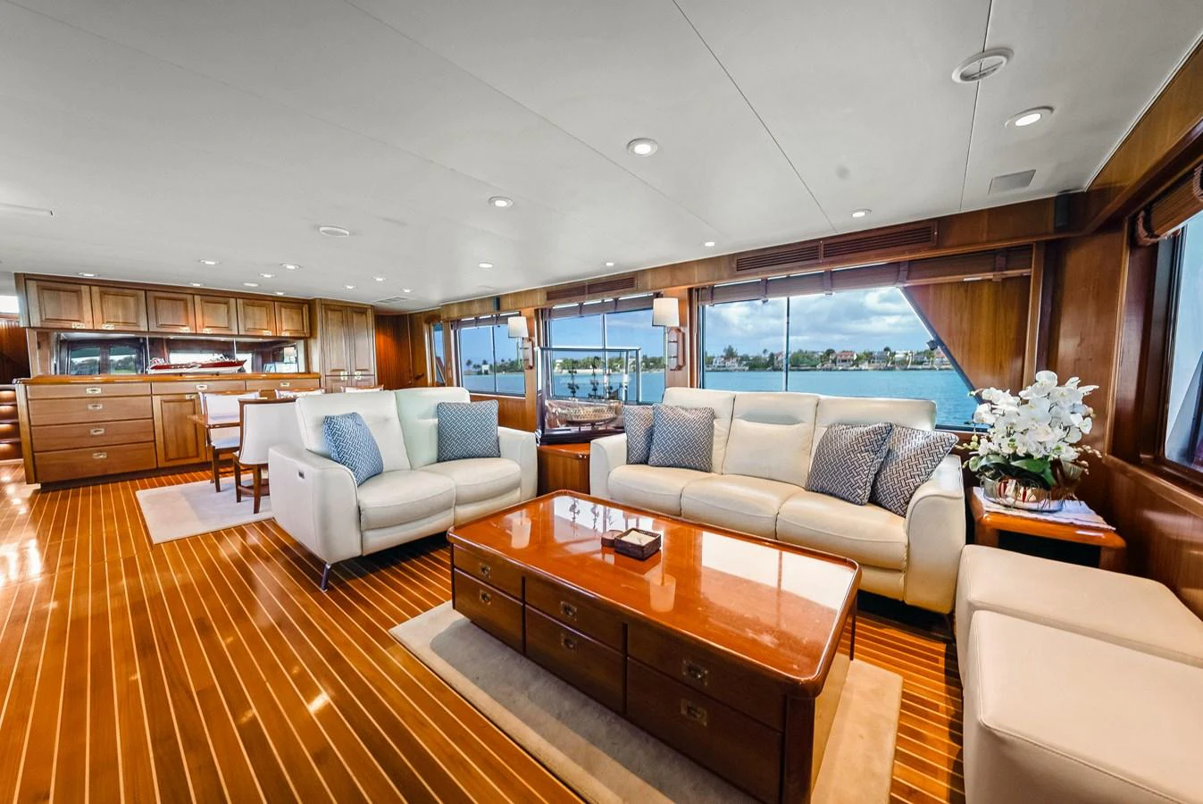 The yacht's salon features luxurious seating with large windows offering stunning views. aboard SERENITY Yacht for Sale