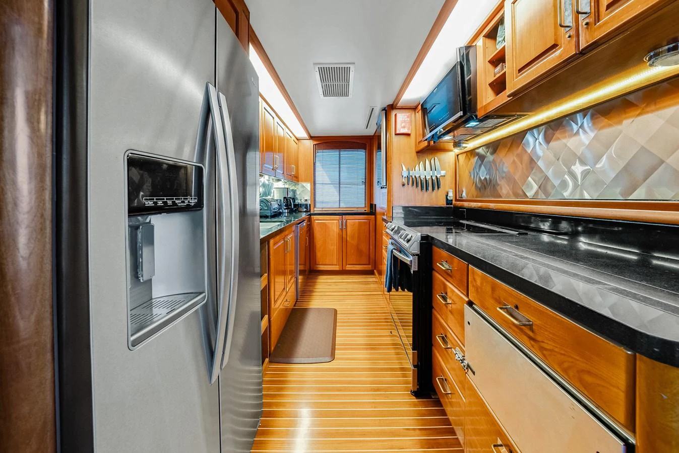 The yacht's galley features modern appliances and ample counter space, perfect for gourmet meal preparation. aboard SERENITY Yacht for Sale