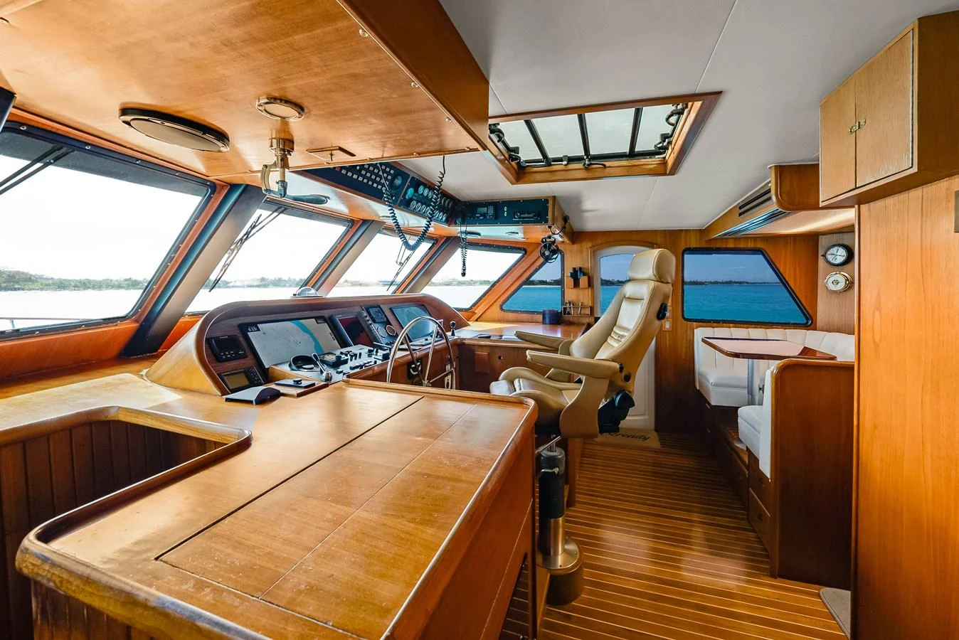 The helm station features a sophisticated control area with panoramic windows and luxurious seating. aboard SERENITY Yacht for Sale