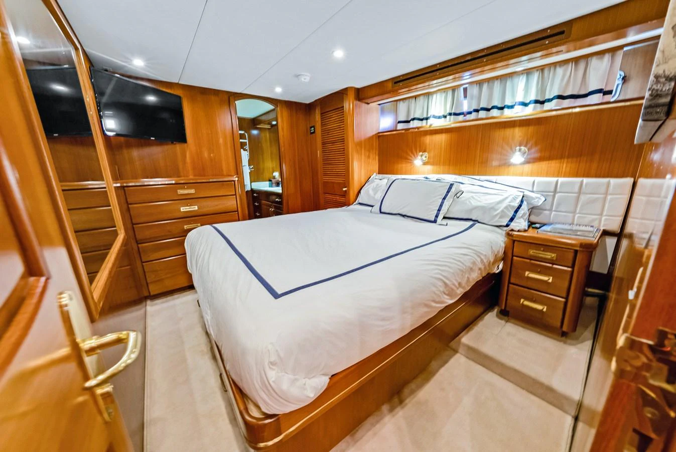 A luxurious stateroom featuring a comfortable bed with elegant bedding and ample storage space. aboard SERENITY Yacht for Sale
