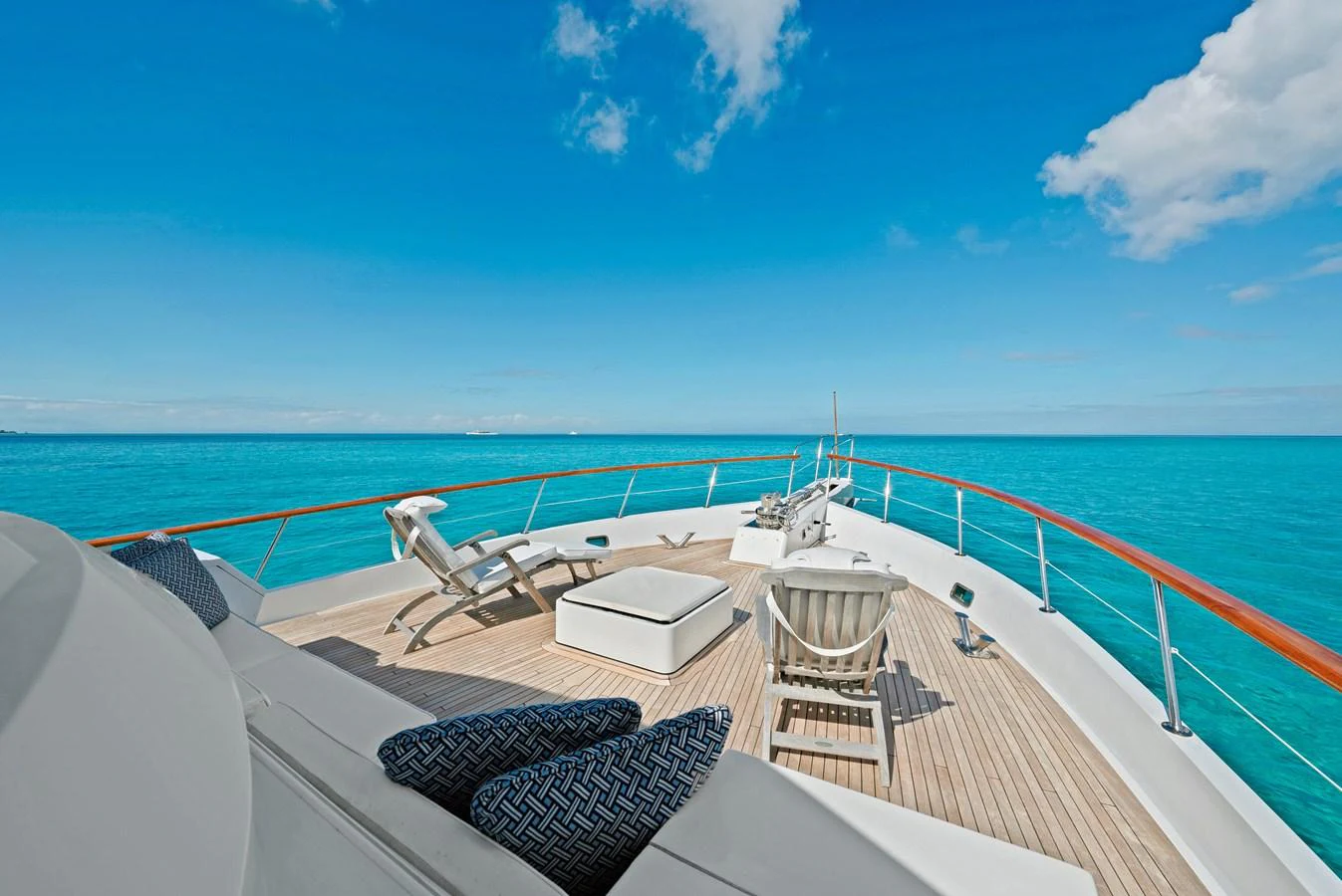 The foredeck offers a serene space with sun loungers and stunning ocean views. aboard SERENITY Yacht for Sale