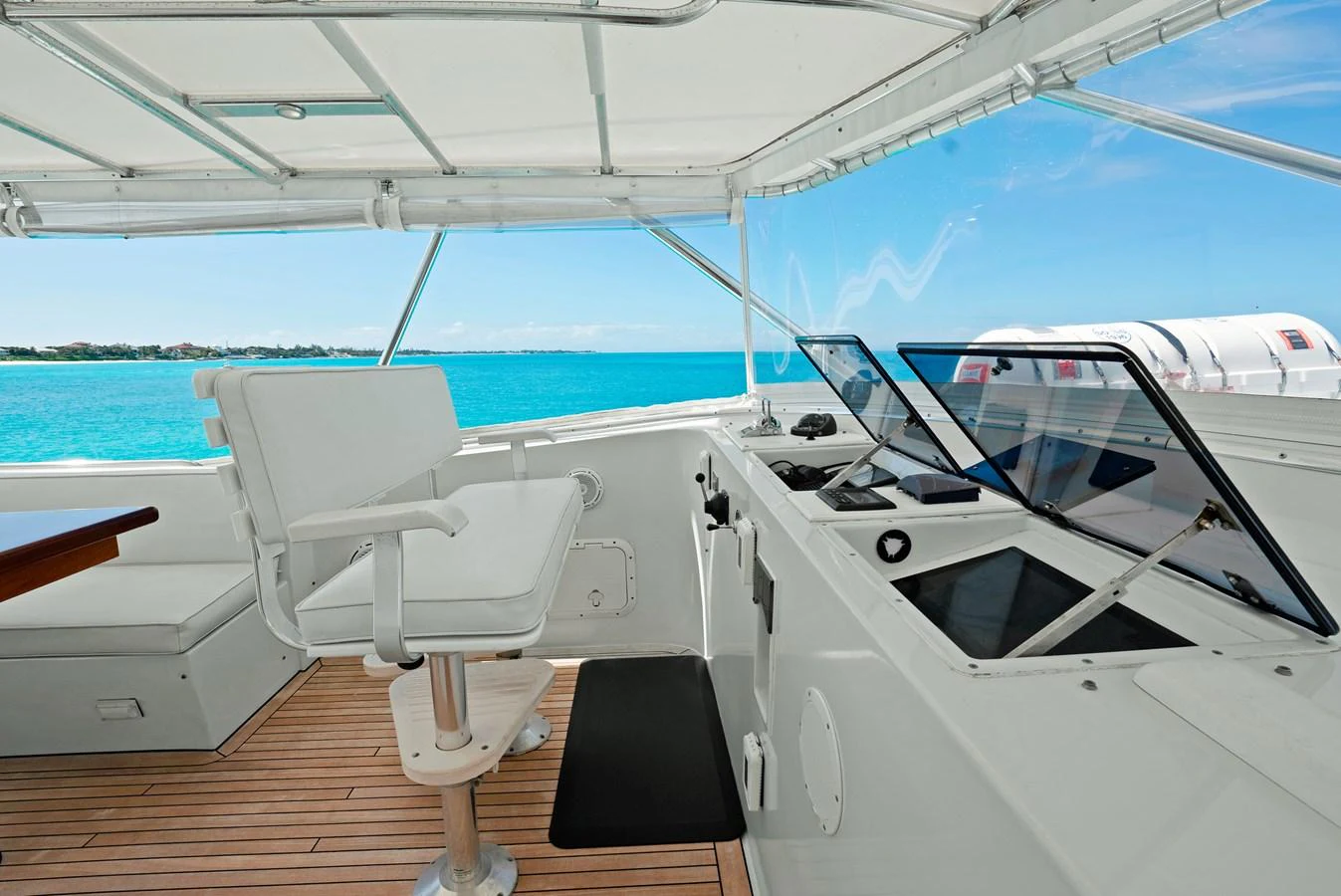 The helm station offers a commanding view with modern navigation equipment and comfortable seating. aboard SERENITY Yacht for Sale