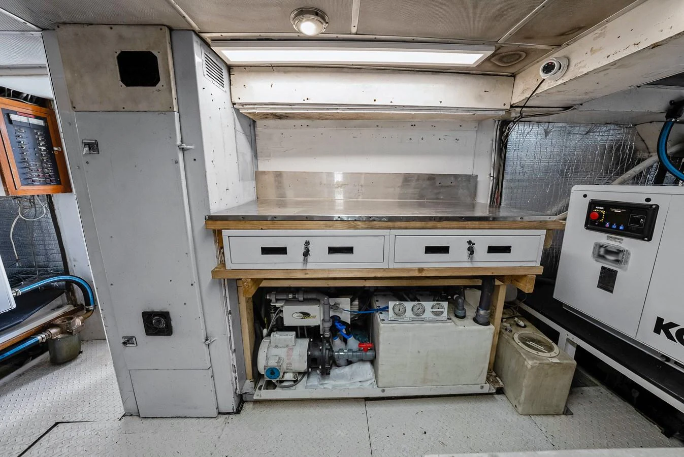 The image showcases a well-organized utility or engine room area on the yacht, featuring various equipment and storage solutions. aboard SERENITY Yacht for Sale