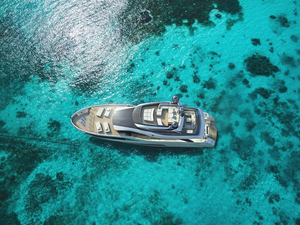 A luxurious yacht cruises through crystal-clear turquoise waters, showcasing its sleek design and spacious deck areas. aboard FILIPPETTI N28-01 Yacht for Sale