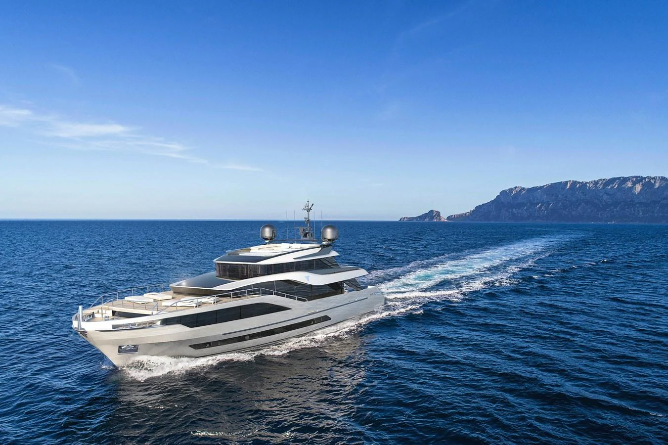 A sleek and modern yacht cruises through open waters with a scenic coastline in the background. aboard FILIPPETTI N28-01 Yacht for Sale