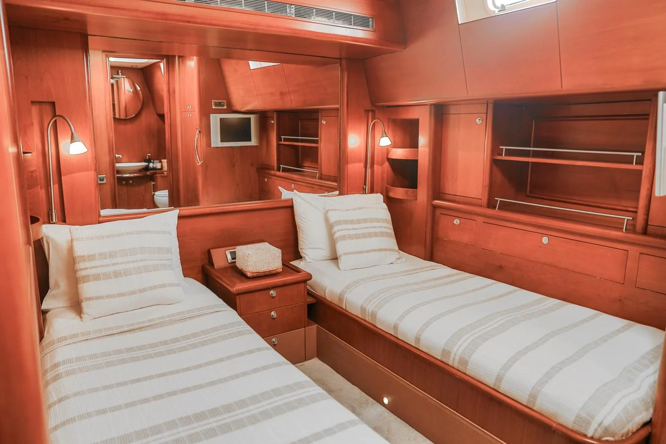 The twin stateroom features two single beds with elegant wood paneling and modern amenities. aboard GOLDEN TOUCH Yacht for Sale