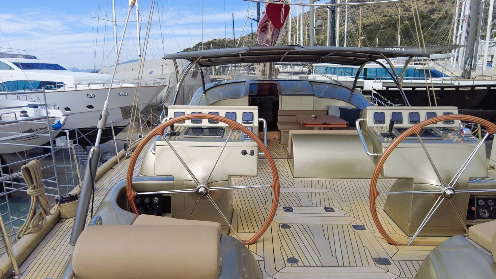 The yacht's helm area features dual steering wheels and a spacious deck, perfect for navigating and enjoying the open sea. aboard GOLDEN TOUCH Yacht for Sale