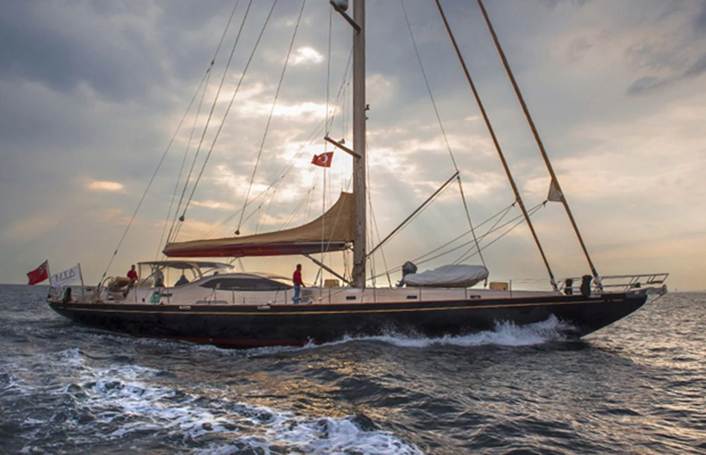 A stunning sailing yacht glides gracefully through the water at sunset. aboard GOLDEN TOUCH Yacht for Sale