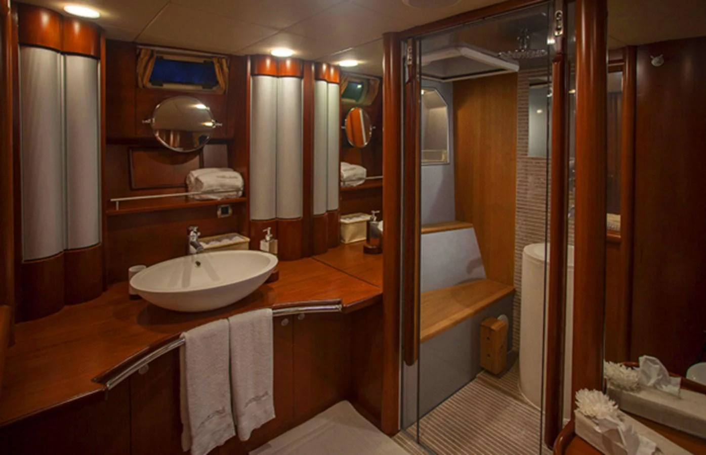 The yacht's bathroom features elegant wood finishes and modern fixtures. aboard GOLDEN TOUCH Yacht for Sale