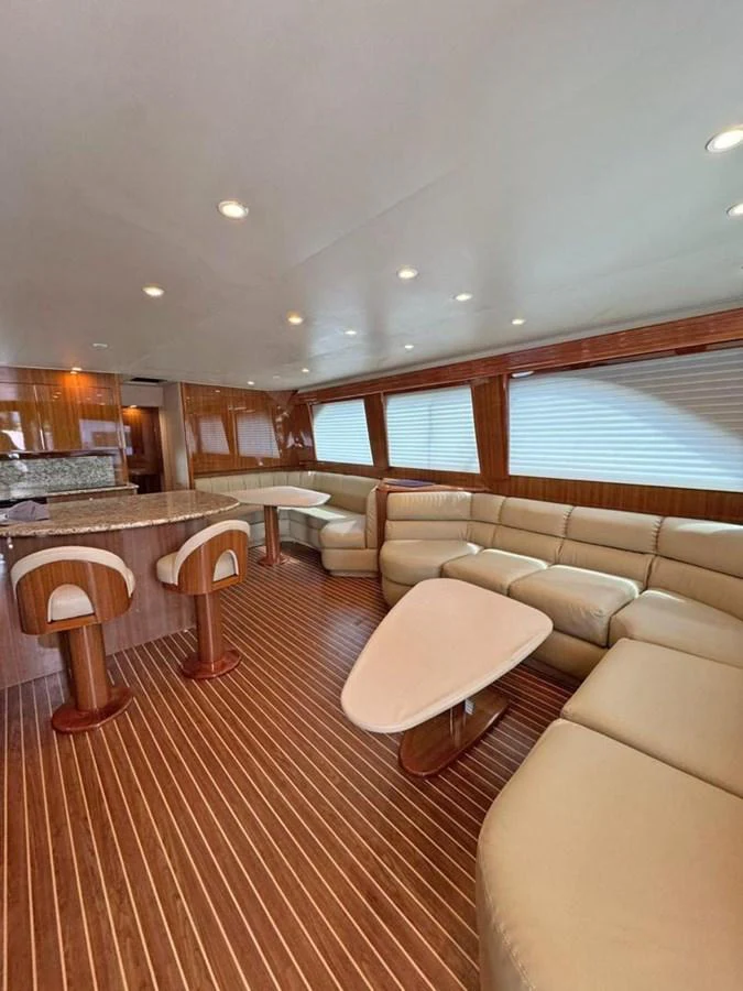 The yacht's salon features luxurious seating and elegant wood finishes, creating a warm and inviting atmosphere. aboard VIKING 68 CONVERTIBLE Yacht for Sale