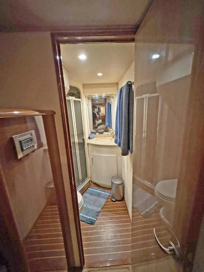 The yacht's bathroom features a compact and functional design with modern amenities. aboard VIKING 68 CONVERTIBLE Yacht for Sale