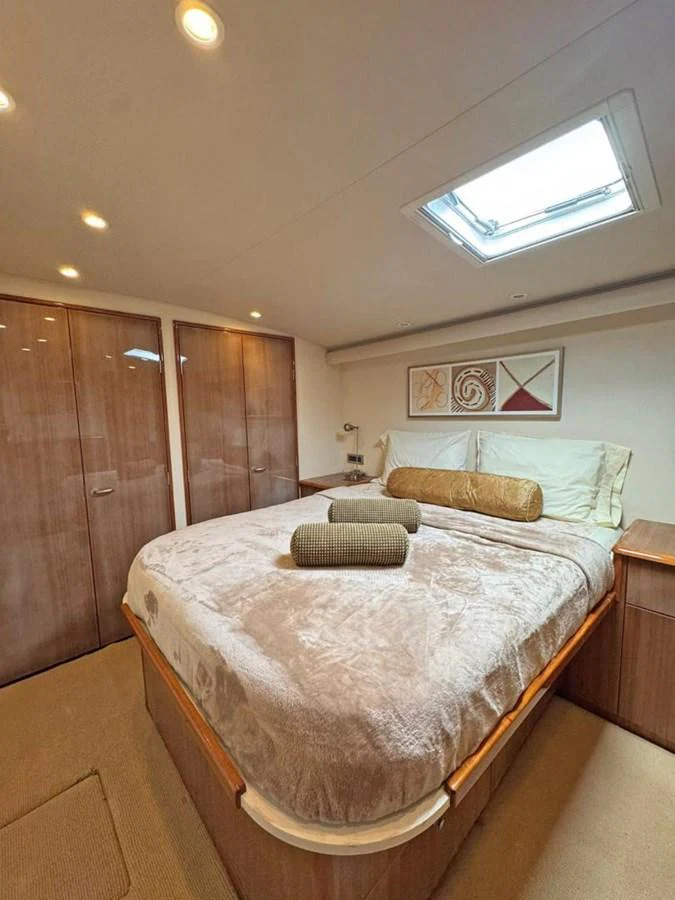 A cozy stateroom featuring a plush bed with soft linens and ample storage space. aboard VIKING 68 CONVERTIBLE Yacht for Sale
