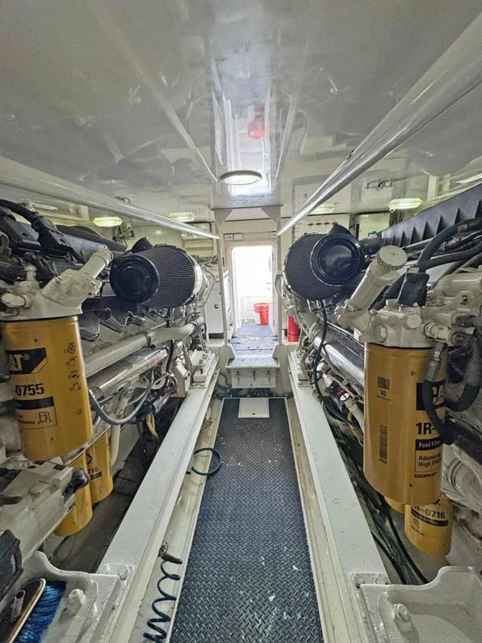 The image showcases the yacht's engine room with powerful machinery and clean, organized space. aboard VIKING 68 CONVERTIBLE Yacht for Sale