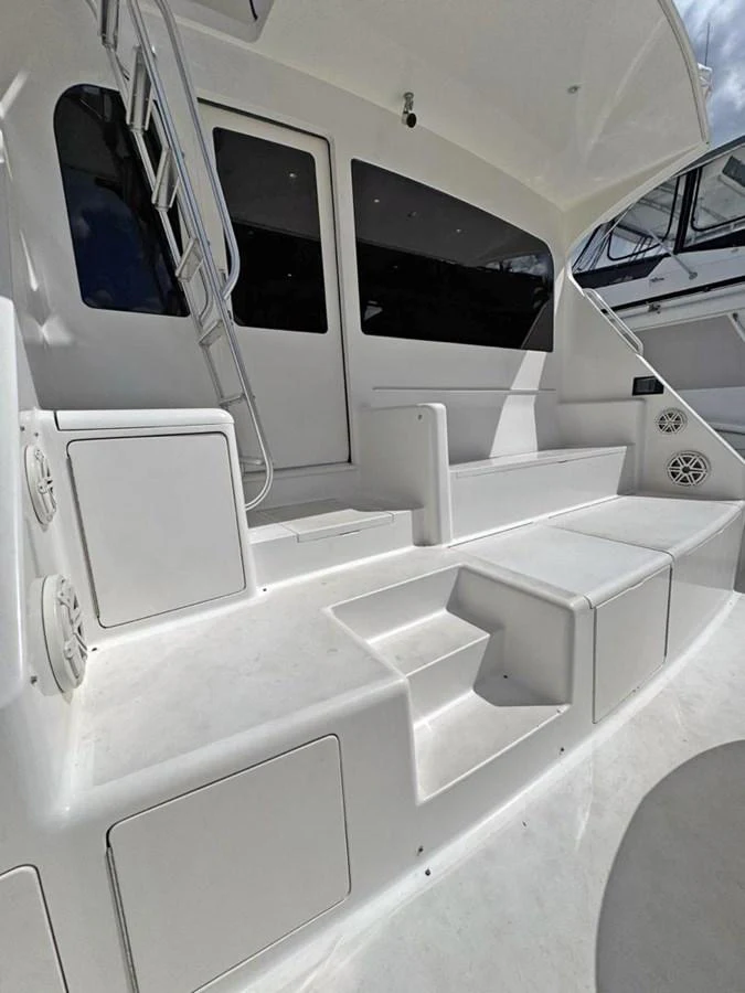 The aft deck features clean lines and practical steps, offering easy access to the interior and upper levels. aboard VIKING 68 CONVERTIBLE Yacht for Sale