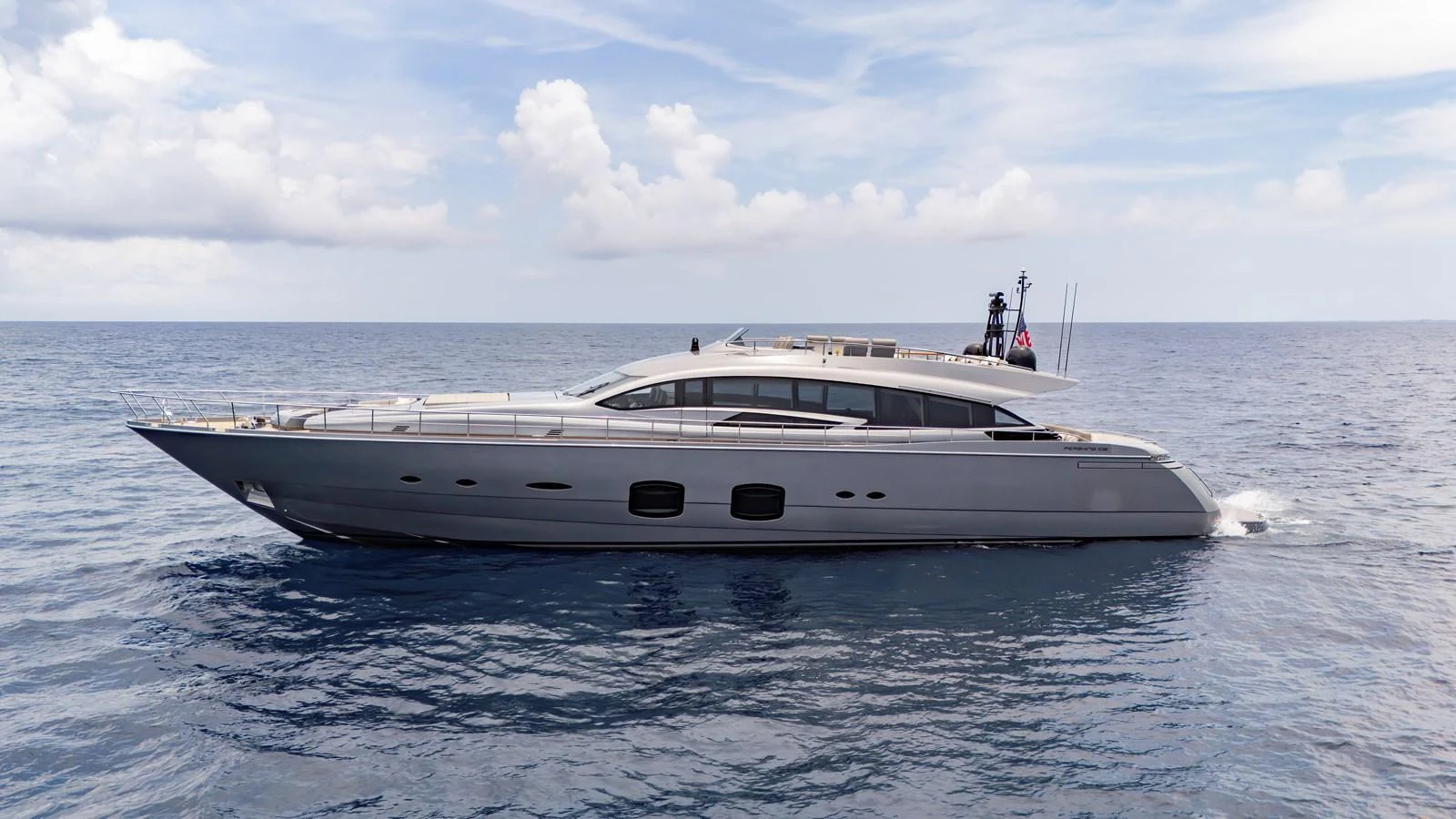A sleek and modern yacht cruising on calm waters under a partly cloudy sky. aboard ANDIAMO II Yacht for Sale