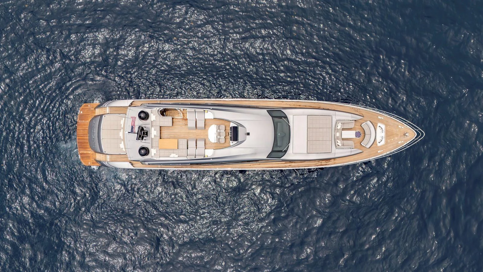 A stunning aerial view of a luxurious yacht cruising on the open sea. aboard ANDIAMO II Yacht for Sale