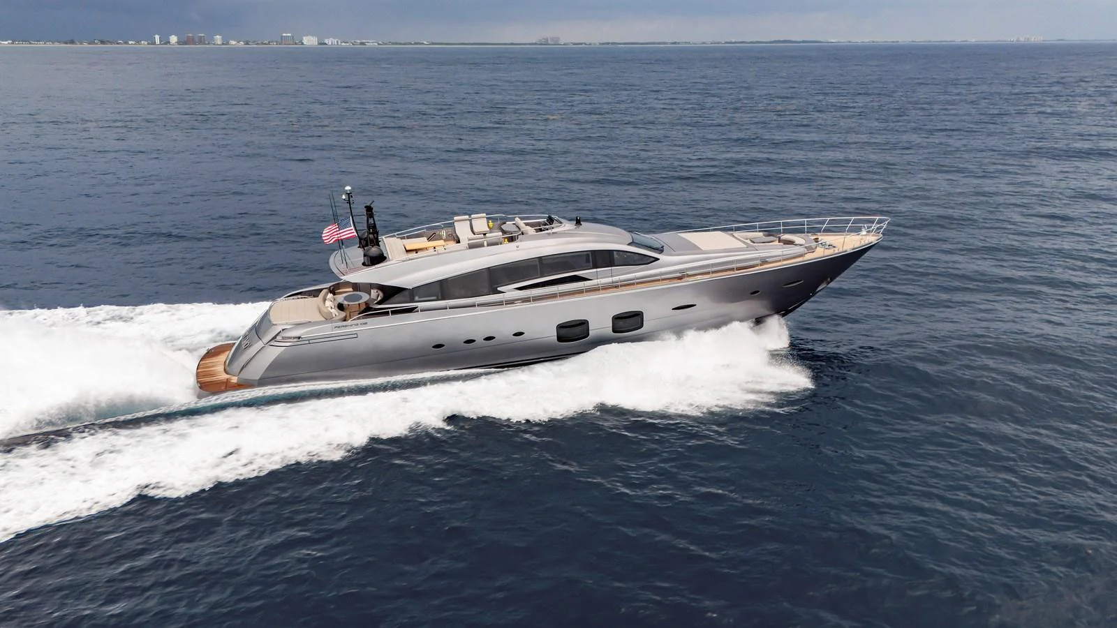 A sleek and modern yacht glides swiftly across the open water, showcasing its elegant design and luxurious features. aboard ANDIAMO II Yacht for Sale