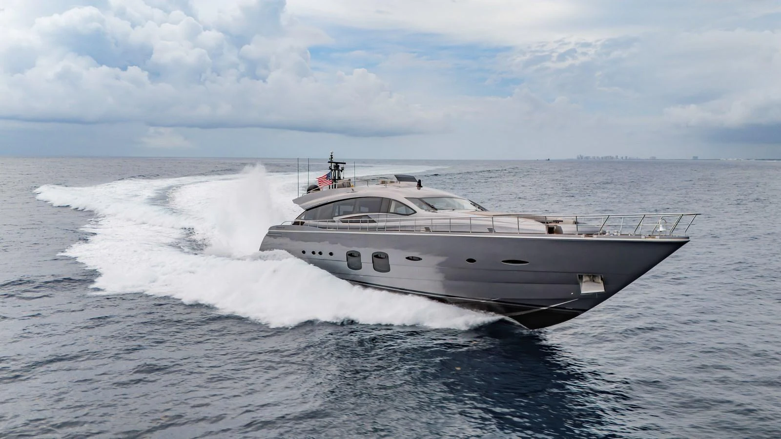 A sleek and modern yacht cruises swiftly through open waters, showcasing its impressive speed and design. aboard ANDIAMO II Yacht for Sale