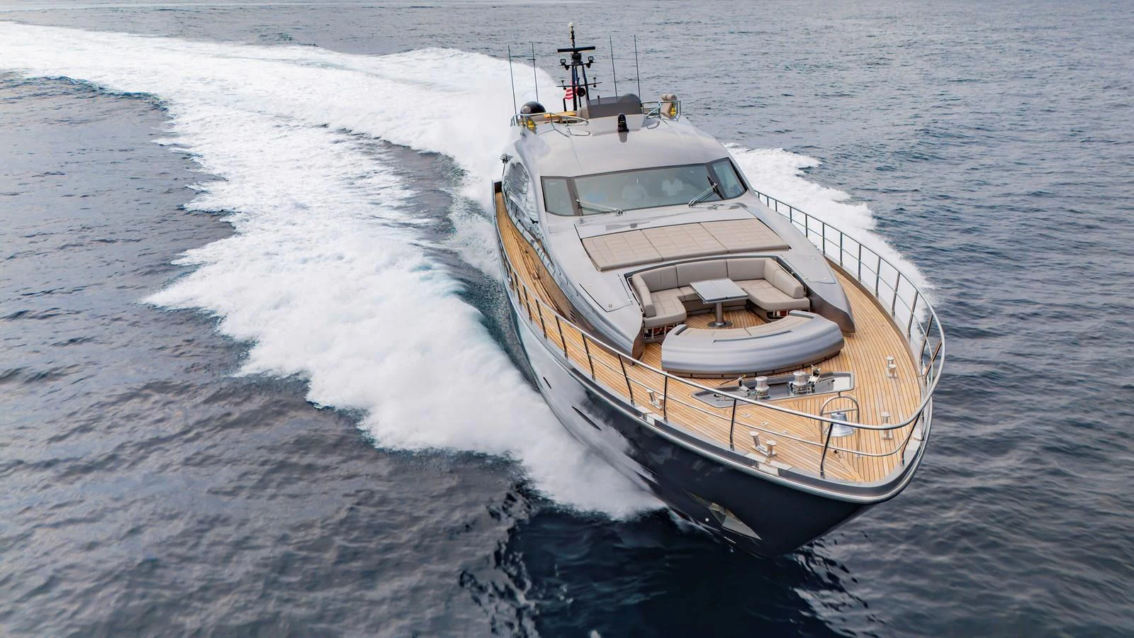 A sleek yacht glides swiftly over the water, showcasing its elegant design and spacious deck. aboard ANDIAMO II Yacht for Sale