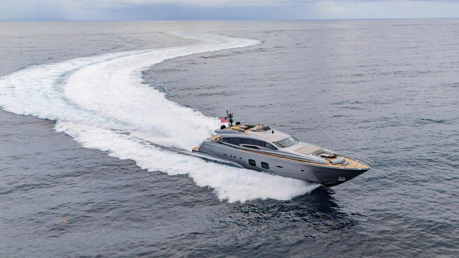 A sleek yacht cruises swiftly through open waters, leaving a dynamic wake behind. aboard ANDIAMO II Yacht for Sale