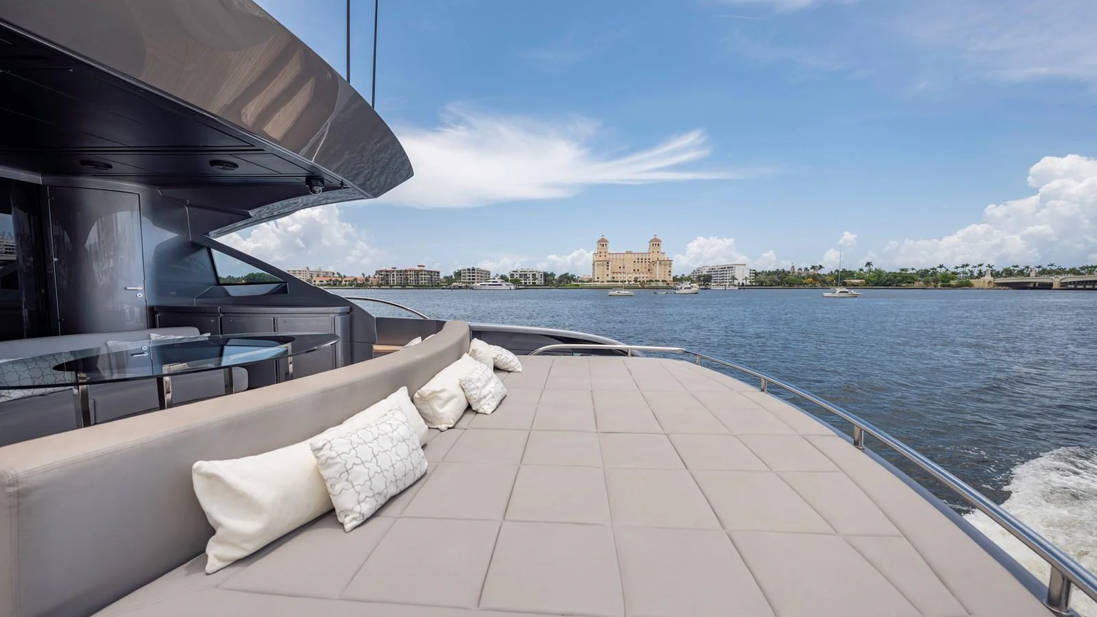The yacht's aft deck features a spacious lounging area with comfortable cushions and scenic views. aboard ANDIAMO II Yacht for Sale