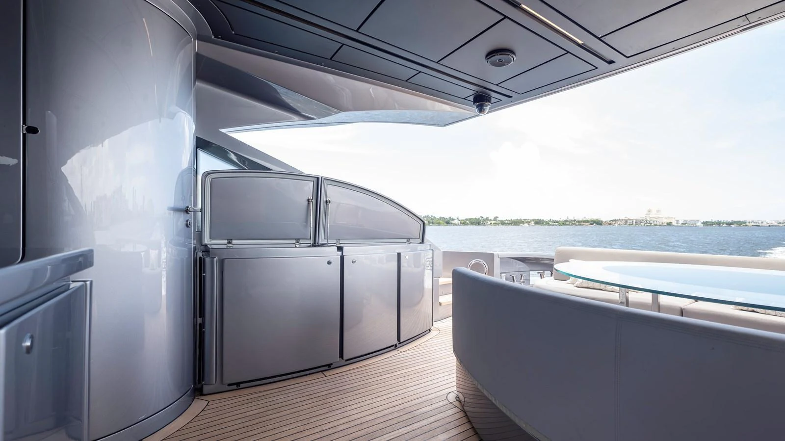 The aft deck offers a sleek and modern space with a view of the water. aboard ANDIAMO II Yacht for Sale