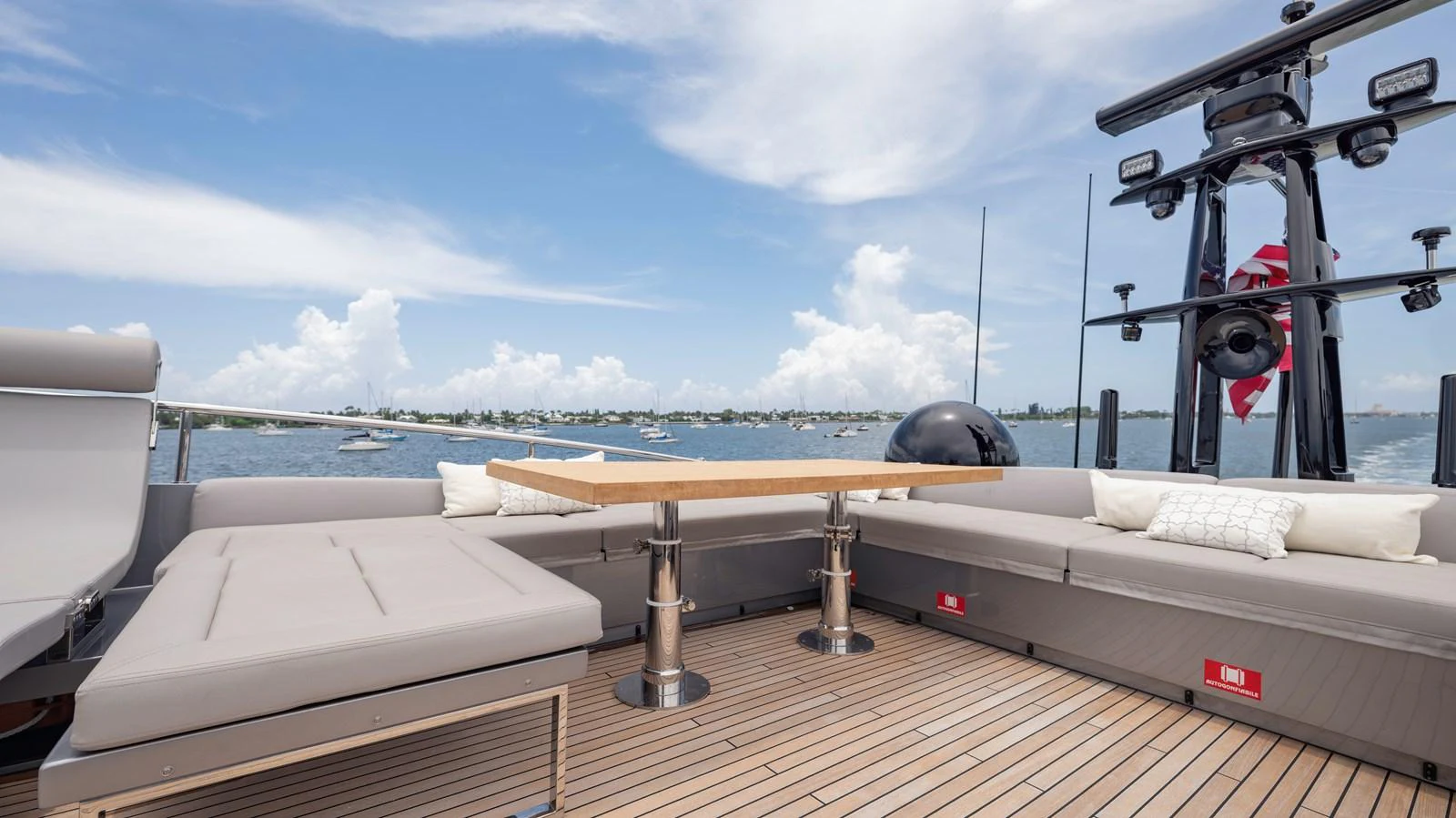 The aft deck features a spacious seating area with a central table, perfect for outdoor relaxation and dining. aboard ANDIAMO II Yacht for Sale