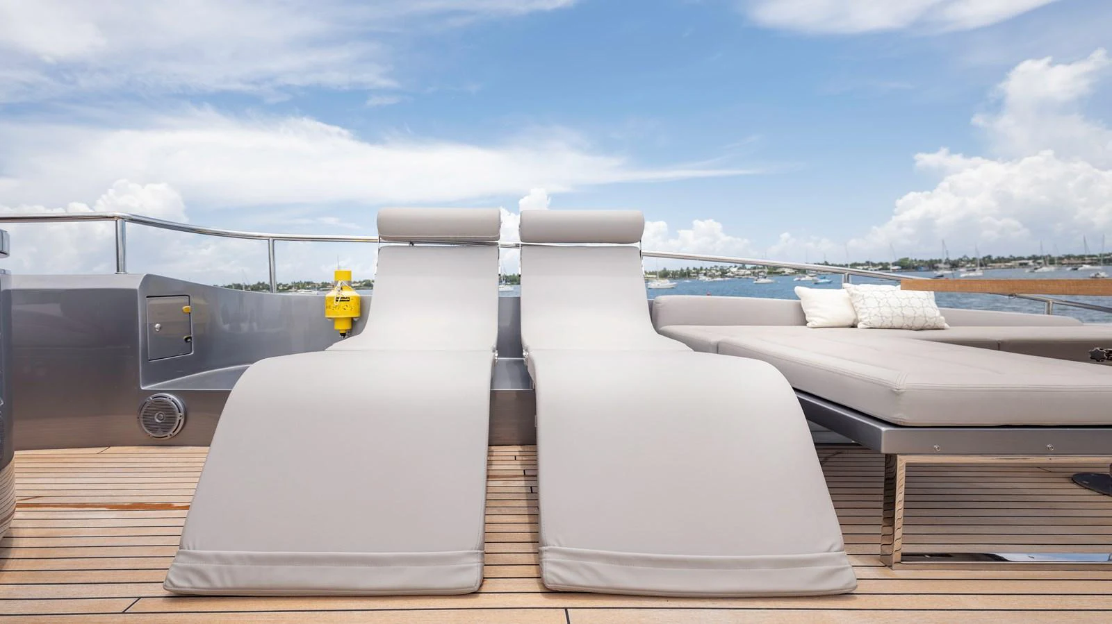 The sundeck features comfortable lounge chairs and a plush sunbed, perfect for relaxation under the open sky. aboard ANDIAMO II Yacht for Sale