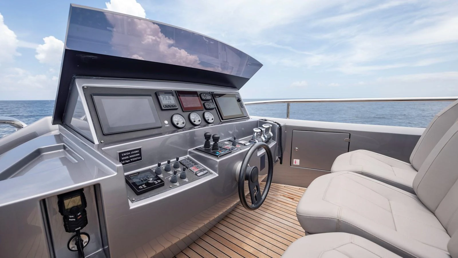 The helm station features modern navigation equipment and comfortable seating, offering a commanding view of the open sea. aboard ANDIAMO II Yacht for Sale