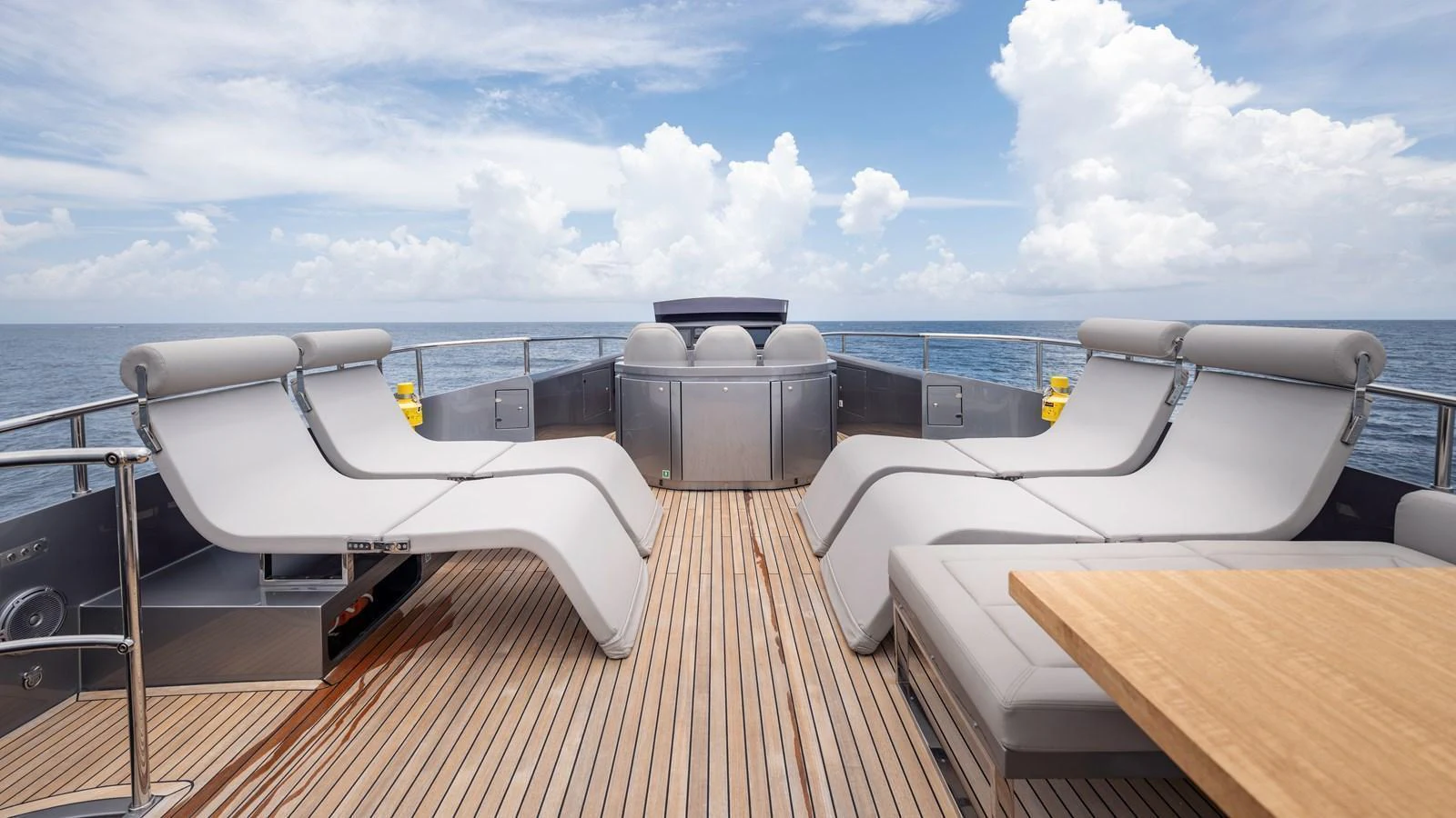 The sundeck offers a serene space with luxurious loungers and a stunning ocean view. aboard ANDIAMO II Yacht for Sale